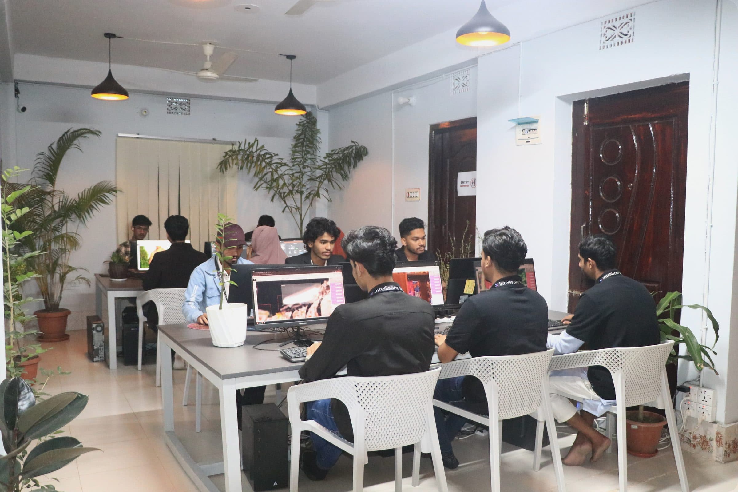 Annotators working at their desks in the Intellisane AI office
