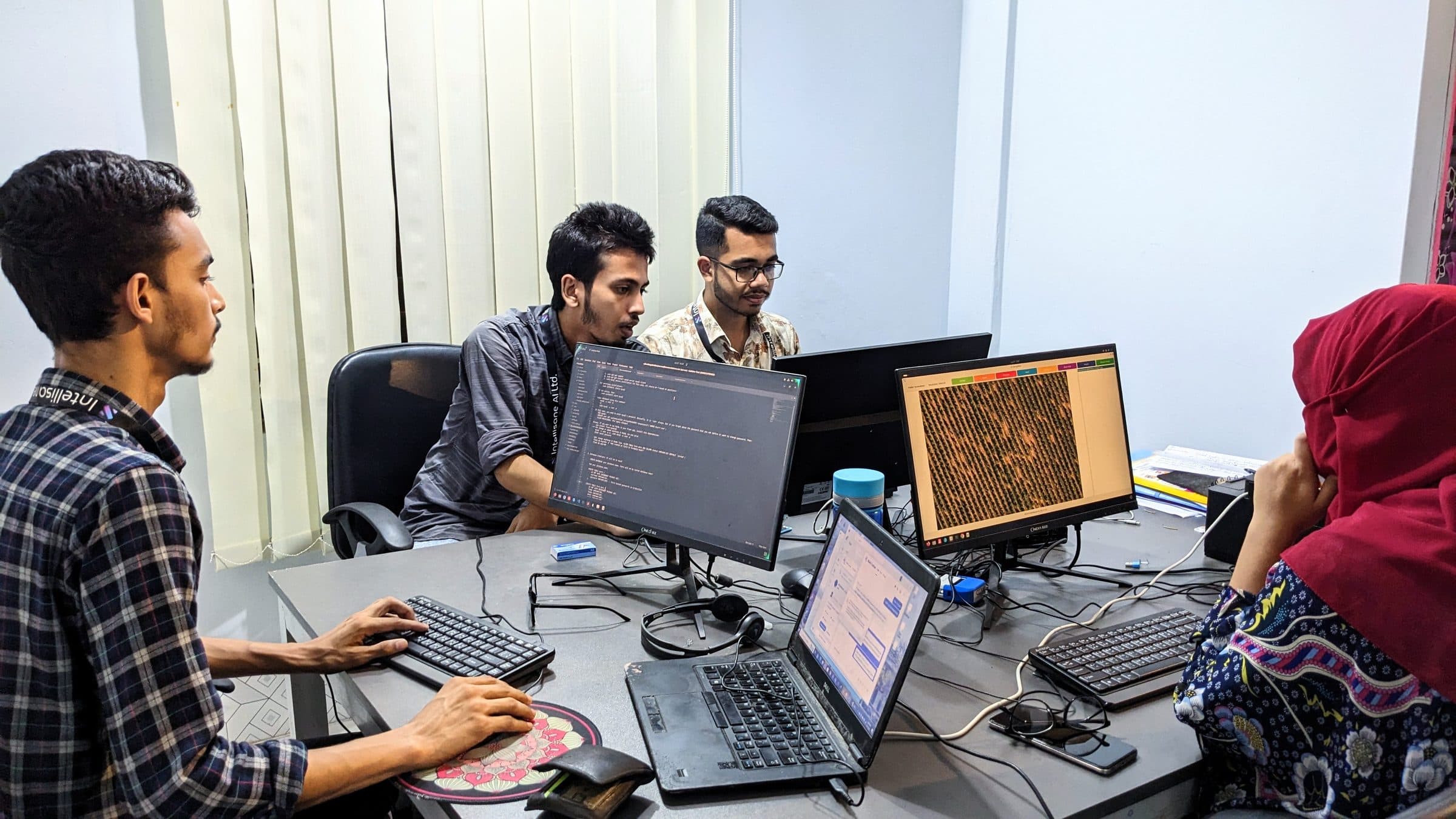 Engineers reviewing annotation work on multiple monitors