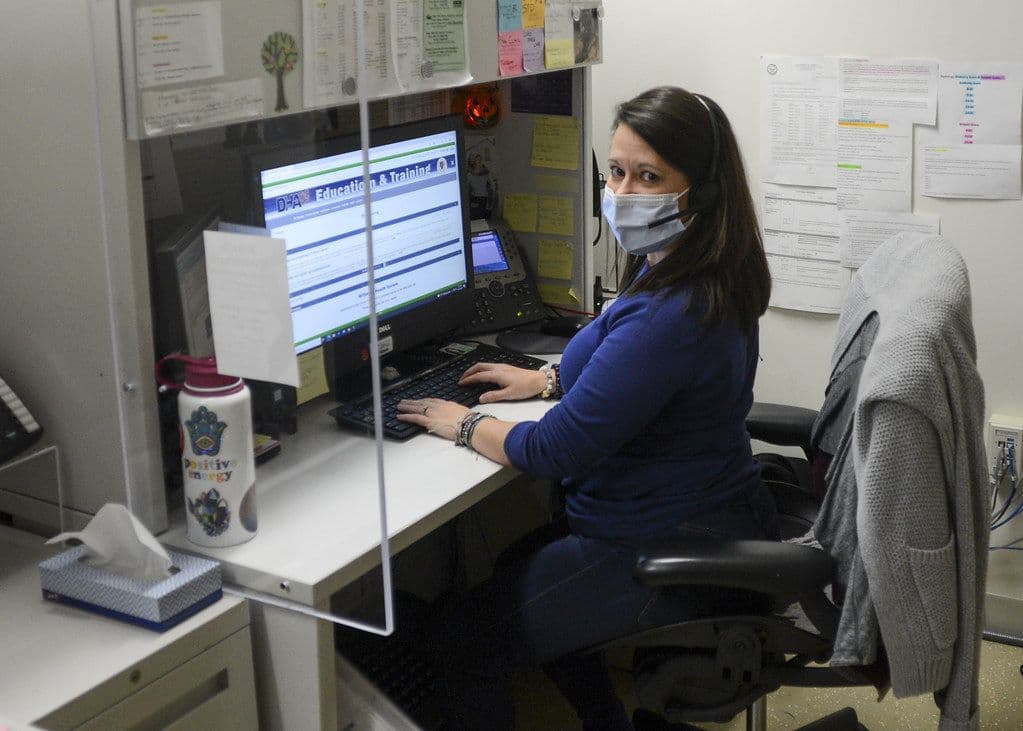 Call-center dispatcher with a headset at her desk