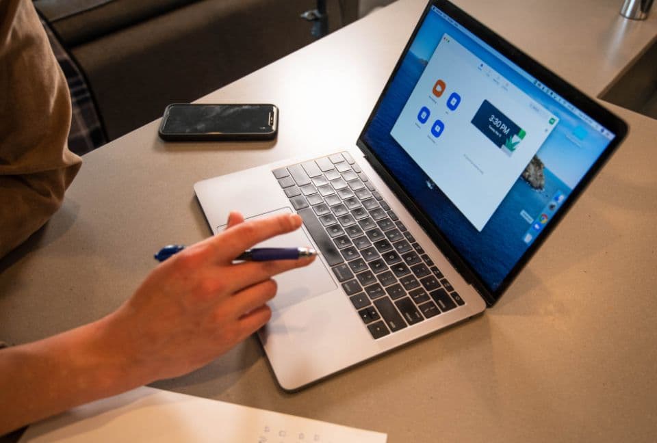Person working on a laptop at a desk