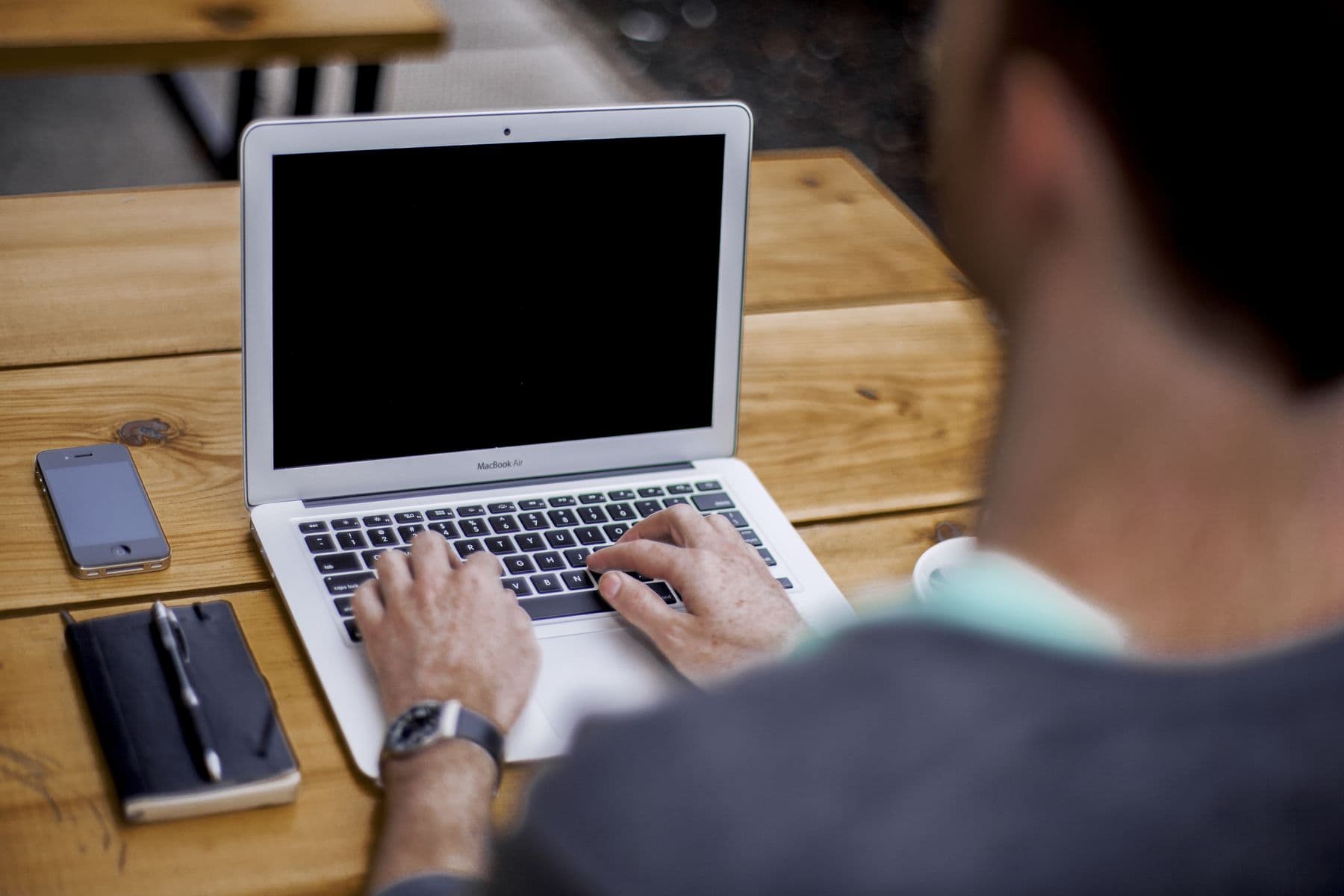 Hands typing on a laptop keyboard