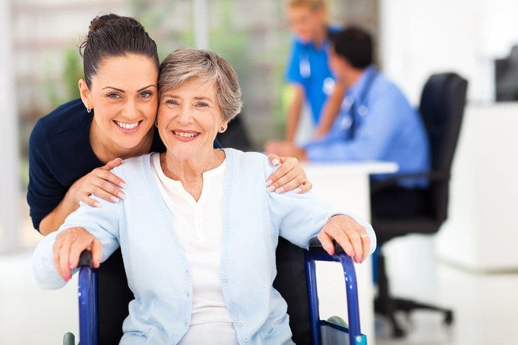 Nurse with an elderly patient in a wheelchair
