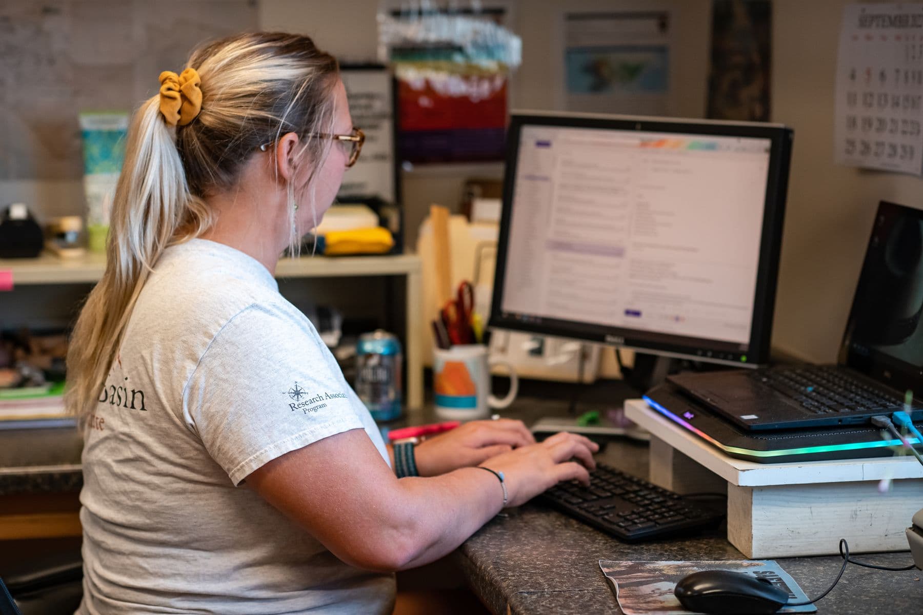Woman working at a desk with a computer