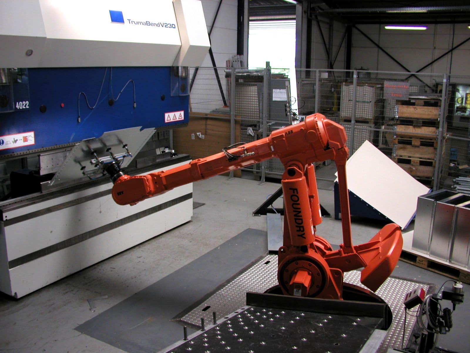 Industrial robot arm working in a production cell