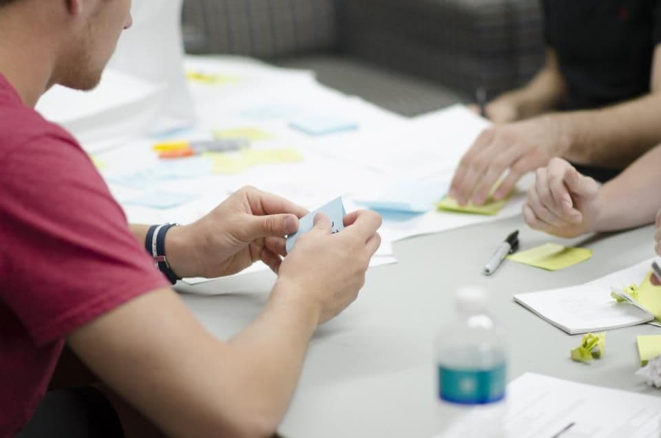 Team organizing ideas with sticky notes