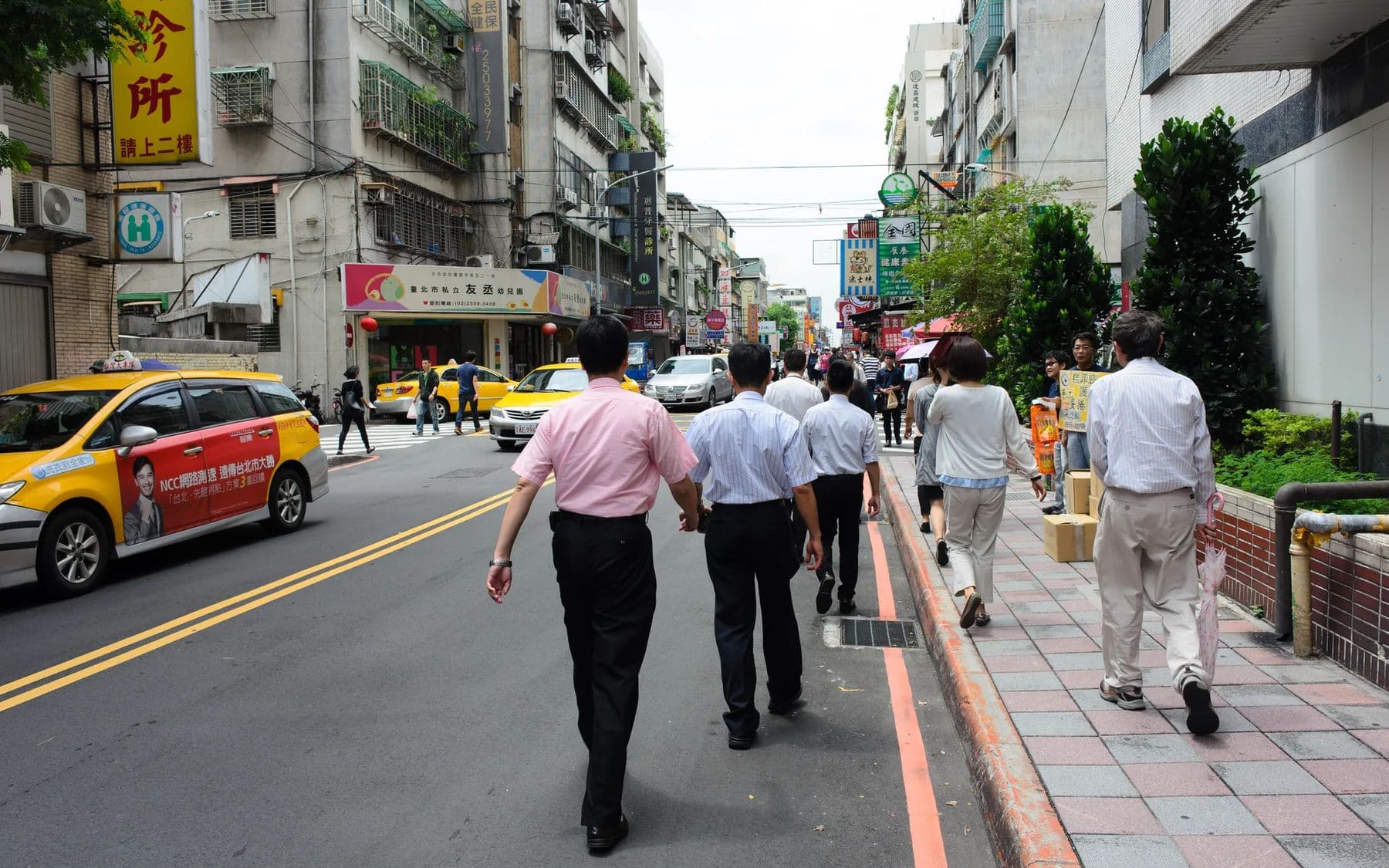 Busy city street with pedestrians and taxis