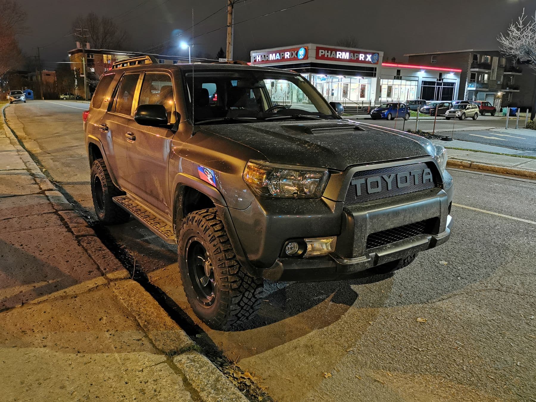 SUV parked on a street at night