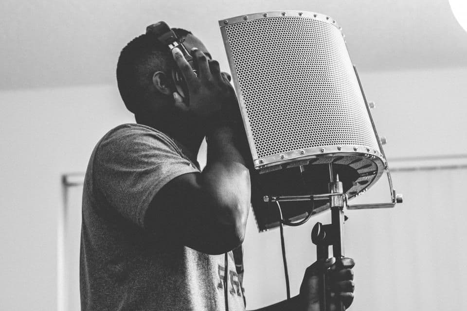 Singer recording in a vocal booth