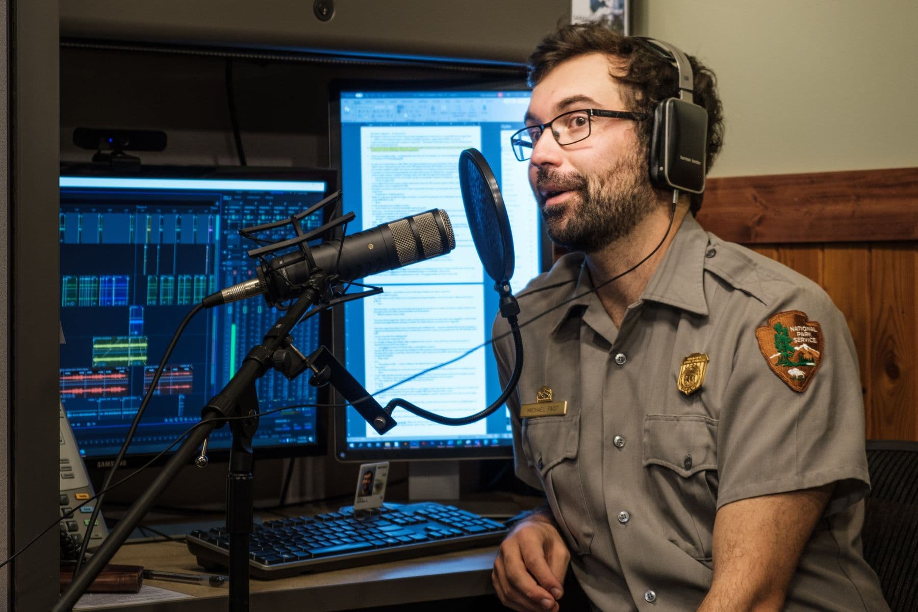 Narrator recording at a studio microphone
